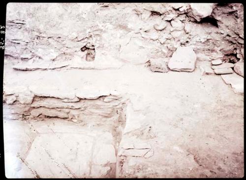 Kiva A, rear wall of E. bench, shows rocks with pits in wall and two other such rocks