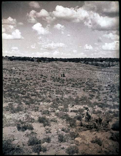 View across flat area. Two people mid-distance