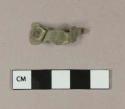 Copper alloy decorative element fragment, possibly a buckle