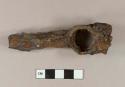 Unidentified iron hardware fragment: ring closed with a screw, attached to a tube