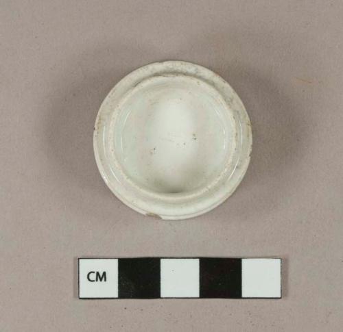 Undecorated whiteware drug pot, stamped on the bottom with "MAW"