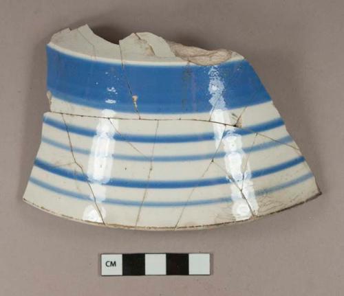 Blue hand painted whiteware partial bowl; glued sherds; crossmends with two undecorated whiteware body sherds