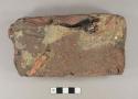 Brick fragment with glaze and redware vessel fragments adhered to it; possibly from a kiln