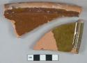 Brown and greenish brown lead glazed redware vessel rim fragments, red paste