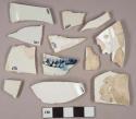 White pearlware vessel base, body, and rim fragments, 1 fragment with molded and blue handpainted decoration, white paste