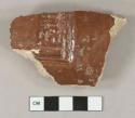 Brown opaque lead glazed earthenware fragment, stamped decoration, buff paste, possible drain pipe fragment
