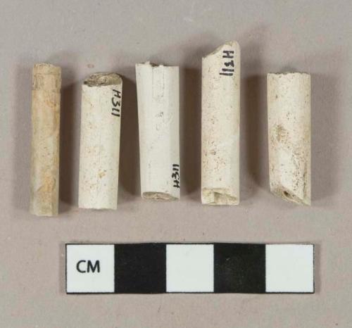 White kaolin pipe stem fragments, 1 with illegible stamp around stem, 1 stamped with "[...]rray" and "Glas[...]" on either side of stem, 1 with 4/64" bore diameter, 3 with 5/64" bore diameter, 1 with 6/64" bore diameter