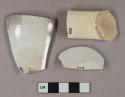 Undecorated whiteware vessel rim, base, and handle fragments, white paste, rim fragment burned
