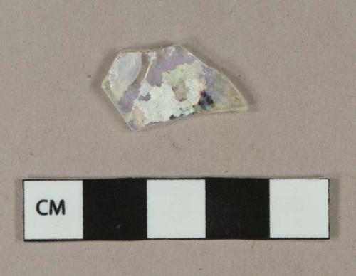 Colorless flat glass fragment, some patination