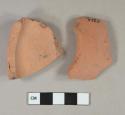 Unglazed undecorated terracotta vessel base and body fragments