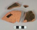 Dark brown lead glazed interior redware vessel body and base fragments