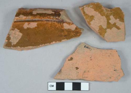 Brown lead glazed redware vessel body and rim fragments