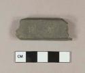 Metal bar fragment, embossed with "HA"; posibly window sash weight