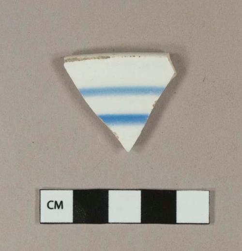 Blue hand painted whiteware rim sherd; crossmends with one blue hand painted whiteware body sherd