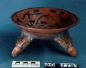 Tripod pottery bowl - black and red on orange; tripod feet are eagle heads