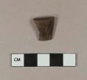 Brown plastic cap fragment, internally threaded