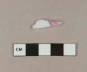 Milk white bottle glass fragment with layer of pink glass on top
