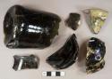 Dark olive green glass round bottle base and body fragments