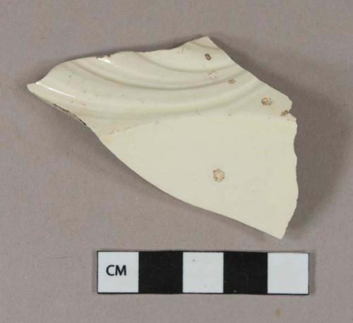 Molded creamware vessel body fragment, white or light buff paste