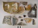 Greenish and dark brown lustrous lead glazed redware vessel body and rim fragments, likely chamberpot