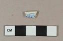 Blue on white transferprinted earthenware vessel rim fragment, light buff paste