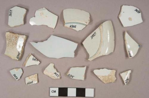 White pearlware vessel base and body fragments, white paste, 2 fragments blue decorated