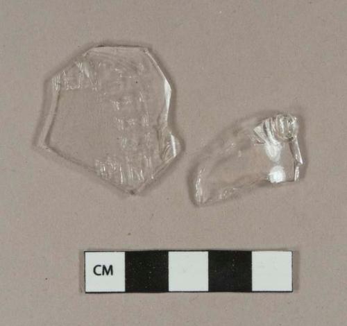 Colorless bottle glass fragments; one embossed with "O", one embossed with "...ANTEED / PINT"