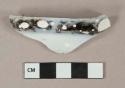 Flow black transferprinted pearlware vessel body fragment, white paste