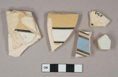 Blue, black, white, and yellow annular slip decorated earthenware vessel body fragments, buff paste