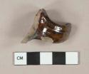 Mottled brown lustrous lead glazed earthenware vessel body fragment with handle fragment, gray paste