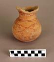 Pottery jar with red painted decoration