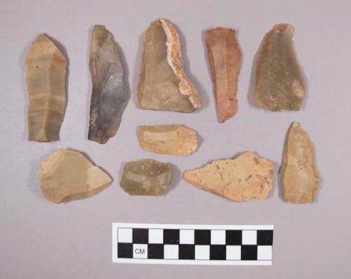 Flint flakes, including tan, cream, grey, brown and red colored stone, some contain cortex
