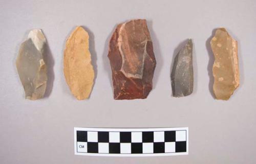 Flint flakes, including tan, brown, grey and red colored stone, some contain cortex