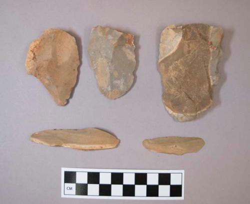 Flint flakes and blades, including tan, brown, grey and cream colored stone, some contain cortex