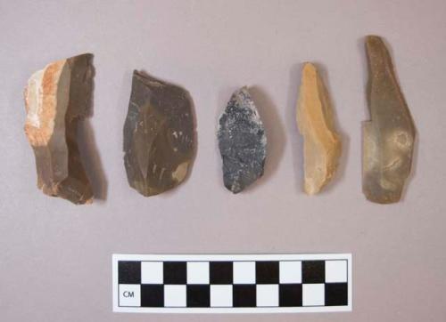 Flint flakes, including tan, grey, brown, cream and black colored stone, some contain cortex