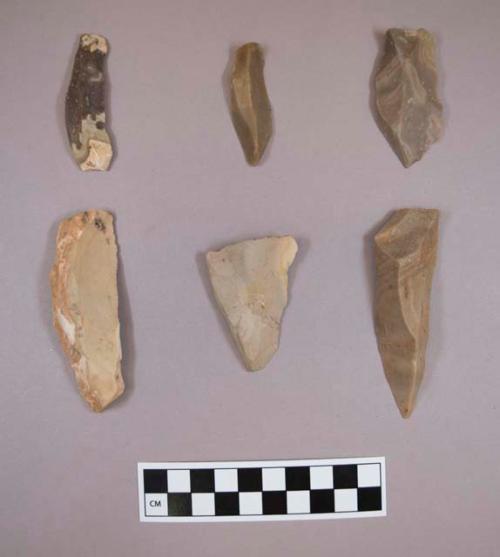 Flint flakes and blades, including tan, brown, grey, purple and cream colored stone, some contain cortex