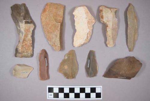 Flint flakes and blades, including tan, cream, brown and grey colored stone, some contain cortex