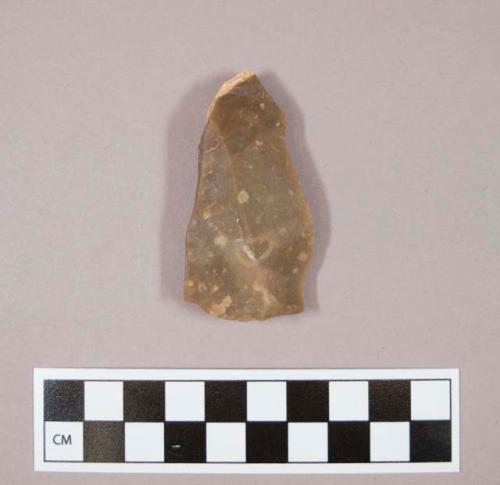 Flint flake, brown colored stone, contains cortex