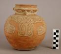 Pottery effigy jar, flat base, red body