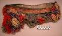 Net bag decorated w/ colored knots of yarn. 48.3x26.2 cm.