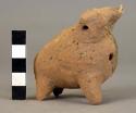 Unpainted pottery animal - two heads, hollow, several perforations