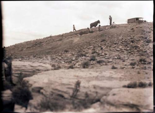 View uphill to site, workmen, slip team