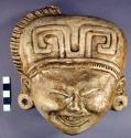 Cast of "laughing face" - geometric design in bas relief on forehead, headdress