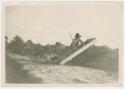 Archaeological explorations, New Jersey, photograph of man sifting near railroad tracks.