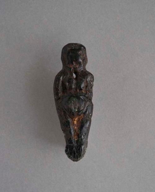 Steatite figurine- female, bifacial, perforation for suspension;