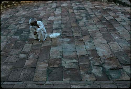 Man in white on stone, Johdpur, India

