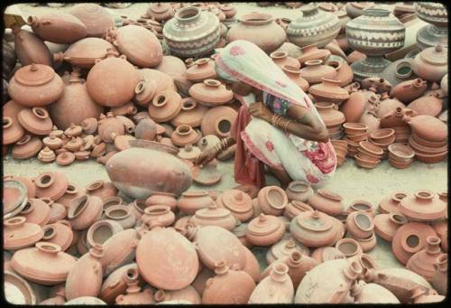 Woman and clay pots - Ramdeora, Mela, India
