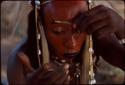 Gerewol dancer applying makeup - Niger
