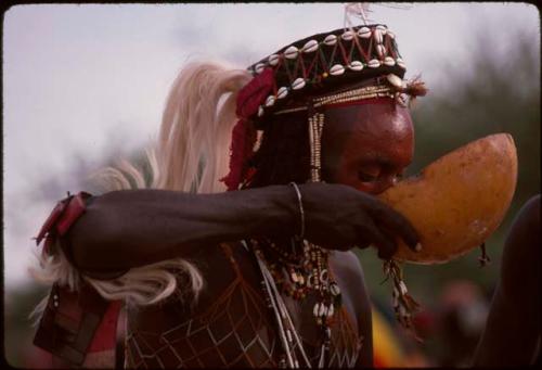 Gerewol dancer drinking from calabash - Niger
