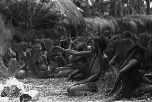 A woman, mourning, reaches out towards Yonokma on the burning funeral pyre